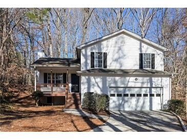 White two-story house with attached garage and deck at 850 Oxford Hall Dr, Lawrenceville, GA 30044