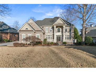 Brick two-story home with a large front yard and professionally landscaped grounds at 3352 Forest Vista Dr, Dacula, GA 30019