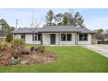 Newly renovated Ranch home with gray roof and landscaped yard at 3590 Ashley Woods Dr, Powder Springs, GA 30127