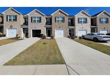 New townhome community with inviting front yards and attached garages at 449 Broder Farms Dr, Stockbridge, GA 30281