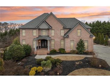Stunning brick home featuring mature landscaping and a welcoming entrance at 206 Woodridge Pkwy, Canton, GA 30115