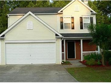 Two-story house with attached garage and landscaping at 517 Carrington Ct, Canton, GA 30115