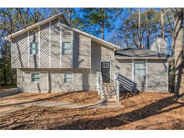 Gray two-story house with white accents and stone detailing at 3485 Tarragon Dr, Decatur, GA 30034