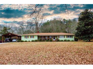 Ranch house with carport and expansive yard at 1400 New Hope Church Rd, Loganville, GA 30052