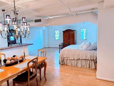 Spacious bedroom with hardwood floors and a metal bed frame at 32 Peachtree Nw St # 1704, Atlanta, GA 30303