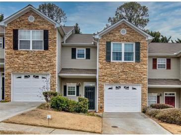 Two-story townhome with stone accents and two-car garage at 103 Linton Dr # 1, Acworth, GA 30102