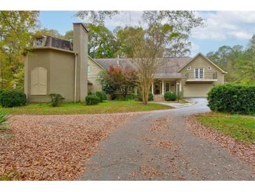 Two-story house with a large front yard and circular driveway at 2812 Highway 16 E, Sharpsburg, GA 30277