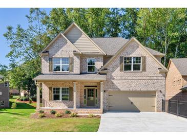Two-story brick home with a large driveway and landscaped yard at 741 Cams Crk, Mcdonough, GA 30253