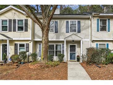 Updated townhome exterior boasts a charming front porch and walkway at 634 Stratford Grn, Avondale Estates, GA 30002