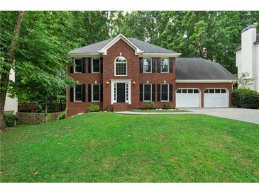 Brick house with 2-car garage and lush lawn at 581 Braidwood Nw Dr, Acworth, GA 30101