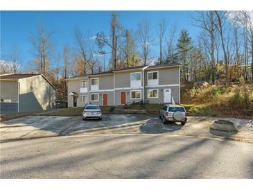 Three-unit building with parking and wooded backdrop at 524 Granite Ridge Pl, Atlanta, GA 30350