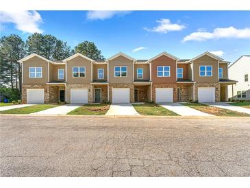 New townhomes feature brick and neutral siding, garages, and well-maintained lawns at 3607 Brycewood Dr, Decatur, GA 30034