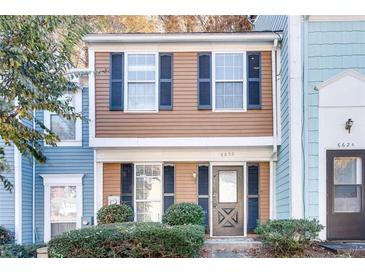 Updated townhome with attractive exterior and landscaping at 6622 Wellington Sq, Norcross, GA 30093