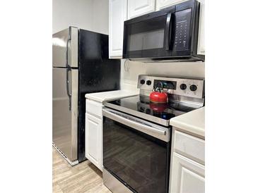 Modern kitchen features stainless steel appliances and white cabinetry at 16103 Waldrop Cv, Decatur, GA 30034