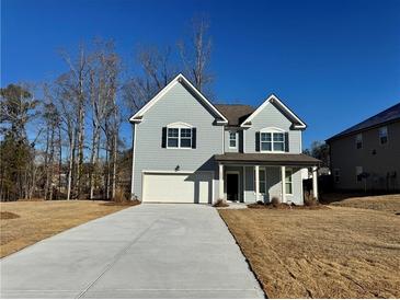 Two-story house with gray siding, a white garage door, and a covered porch at 4005 Riverchess Lot 127 Sw Dr, Atlanta, GA 30331