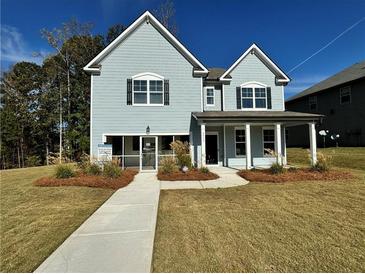 Two-story house with light blue siding, a front porch, and landscaping at 4005 Riverchess Lot 127 Sw Dr, Atlanta, GA 30331