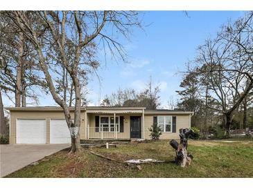 Ranch style home with attached two-car garage and a spacious yard at 1203 Sandune Dr, Norcross, GA 30093