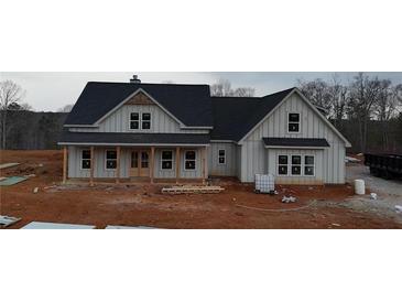 Two-story farmhouse with gray siding, black roof, and a front porch at 1330 Temple Draketown Rd, Temple, GA 30179