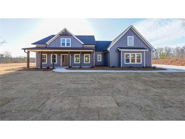 Charming exterior view of a two-story home featuring a welcoming front porch and freshly installed yard at 1330 Temple Draketown Rd, Temple, GA 30179