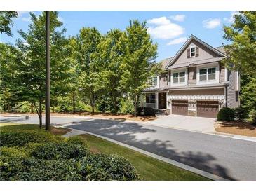 Two-story house with gray siding, brown accents, and a three-car garage at 2741 Prado Ln, Marietta, GA 30066