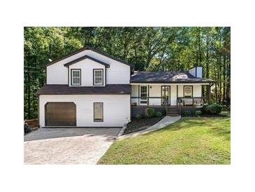 Two-story house with white siding, dark trim, and a two-car garage at 124 Cagle Way, Hiram, GA 30141