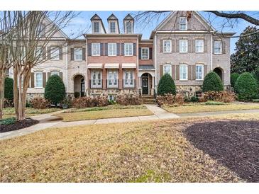 Brick front exterior of charming townhome with manicured lawn at 2344 Saint Davids Nw Sq # 2, Kennesaw, GA 30152