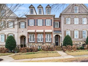 Brick three-story townhome with shutters, balconies, and a manicured lawn at 2344 Saint Davids Nw Sq # 2, Kennesaw, GA 30152