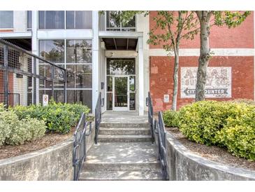 Brick building with gated parking and large windows at 505 Whitehall Sw St # 101, Atlanta, GA 30303