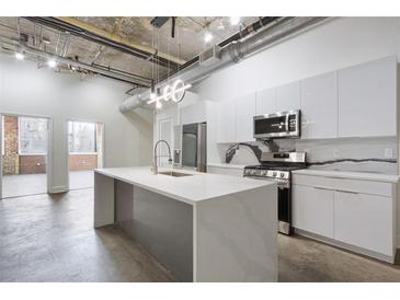 Modern kitchen with white cabinets, marble countertops, and island at 505 Whitehall Sw St # 101, Atlanta, GA 30303