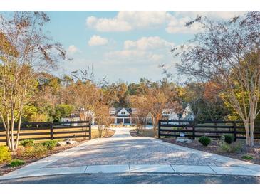 A long driveway leads to a charming farmhouse with a detached barn at 201 Edwards Brook Ct, Canton, GA 30115