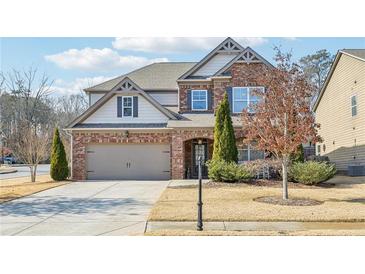 Beautiful two-story home with brick facade and landscaped yard at 2090 Red Barn Ct, Cumming, GA 30040