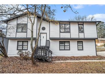 Two-story house with white siding, gray accents, and a wooden staircase at 2649 Porter Dr, Lawrenceville, GA 30044