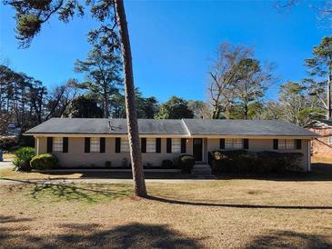 Ranch style home with brick facade, shutters, and a well-manicured lawn at 4427 Sun Valley Blvd, Atlanta, GA 30344