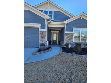 Curb appeal abounds in this charming home featuring stone accents and a welcoming front porch at 532 Barlow Pl, Grayson, GA 30017