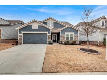 Charming one-story home featuring well-manicured front yard and attached two-car garage at 532 Barlow Pl, Grayson, GA 30017