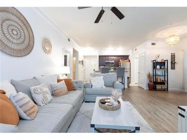 Bright living room with comfy gray sofa and large windows at 955 Juniper St Ne # 4022, Atlanta, GA 30309