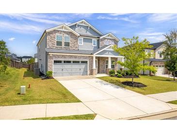 Two-story house with stone accents and a three-car garage at 4745 Billow Sw Way, Mableton, GA 30126