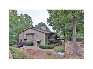 Attractive exterior of a multi-unit building nestled in a wooded setting at 2510 Cumberland Se Ct, Smyrna, GA 30080