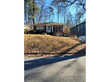 Brick ranch home with screened porch and mature trees at 141 Holly Nw Rd, Atlanta, GA 30314