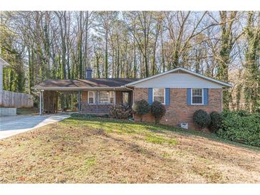 Brick ranch house with carport and mature trees at 3390 Kenland Se Rd, Smyrna, GA 30082