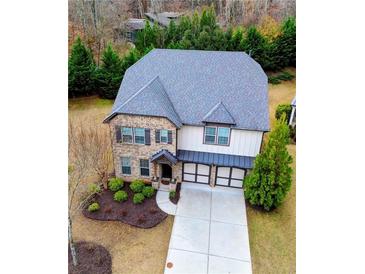 Two-story brick home with gray roof and attached garage at 1055 Grove Valley Dr, Cumming, GA 30041