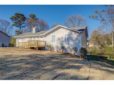 Ranch style home with a wooden deck and large yard at 912 Northridge Nw Dr, Conyers, GA 30012