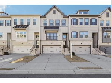 Three-story townhouses with attached garages and front stairs at 505 Stagecoach Bnd, Smyrna, GA 30080