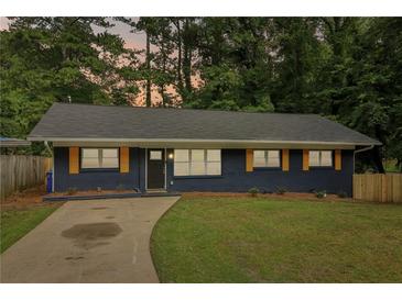 Newly renovated ranch home featuring a modern exterior, freshly painted in blue with orange accents at 2256 Barge Sw Rd, Atlanta, GA 30331