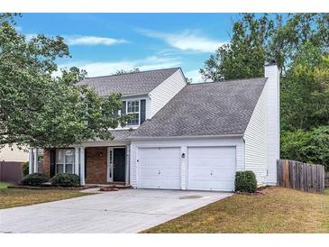 Two-story house with a two-car garage and landscaped lawn at 526 Bass Pointe Nw, Kennesaw, GA 30144