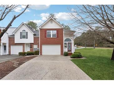 Brick townhouse with attached garage and landscaped yard at 6235 Queen Meadow Se Dr, Mableton, GA 30126