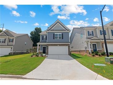 Two-story house with gray siding, white garage door, and landscaped lawn at 730 Brickelberry Court, Marietta, GA 30066