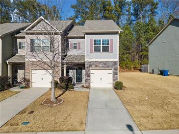 Two-story townhome with stone accents and a two-car garage at 646 Oakside Pl, Acworth, GA 30102