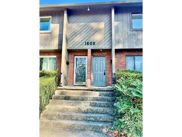 Inviting townhome entry with brick and gray siding at 1608 Briarcliff Ne Rd # 3, Atlanta, GA 30306