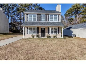 Two-story house with gray roof, beige siding, and black shutters at 7618 Mcgillicuty Dr, Union City, GA 30291
